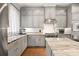 Bright kitchen boasts stainless steel appliances, marble countertops, and grey cabinets offering a blend of style and functionality at 717 Lenox Ln, Atlanta, GA 30324