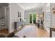 Spacious living area with hardwood floors, a decorative console table, and a door leading to the backyard providing elegance at 717 Lenox Ln, Atlanta, GA 30324