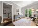 Bright living area with hardwood floors, a decorative console table, and French doors, creating a stylish and inviting space at 717 Lenox Ln, Atlanta, GA 30324
