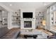 Living room boasts a fireplace, mounted TV, and a gray sectional sofa at 717 Lenox Ln, Atlanta, GA 30324