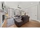 Bright living room with a fireplace, gray sectional sofa, and large windows at 717 Lenox Ln, Atlanta, GA 30324