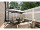 Outdoor patio featuring cozy seating with neutral-toned chairs, surrounded by lush greenery creating a private relaxation space at 717 Lenox Ln, Atlanta, GA 30324