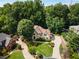 Aerial view of the house showcasing its landscaping, driveway, and surrounding greenery at 820 Chelsea Park Ne Dr, Marietta, GA 30068