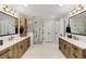 Bright bathroom featuring -and- vanities and a large frameless glass shower with marble tile at 820 Chelsea Park Ne Dr, Marietta, GA 30068