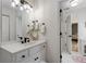 Bright, updated bathroom with white vanity, modern fixtures, and an adjacent walk-in closet at 820 Chelsea Park Ne Dr, Marietta, GA 30068