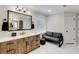 Well-lit bathroom with a rustic vanity, black hardware, and a cozy seating area by the window at 820 Chelsea Park Ne Dr, Marietta, GA 30068