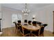 Elegant dining room with hardwood floors, classic chandelier, and large windows with shutters at 820 Chelsea Park Ne Dr, Marietta, GA 30068