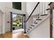 Bright foyer with hardwood floors, stairway with black trim, and glass front doors at 820 Chelsea Park Ne Dr, Marietta, GA 30068
