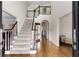 Inviting foyer with hardwood floors, stairway with black trim, and arched doorway at 820 Chelsea Park Ne Dr, Marietta, GA 30068