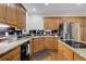Functional kitchen with granite countertops, stainless steel appliances, and wooden cabinetry at 820 Chelsea Park Ne Dr, Marietta, GA 30068