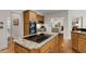 Kitchen island featuring granite countertop and cooktop with views to the Gathering room at 820 Chelsea Park Ne Dr, Marietta, GA 30068