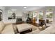Spacious living area with a fireplace, built-in bar, bookshelves, and large windows at 820 Chelsea Park Ne Dr, Marietta, GA 30068