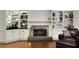 Cozy living room featuring built-in bar, fireplace, and bookshelves, ideal for relaxation at 820 Chelsea Park Ne Dr, Marietta, GA 30068