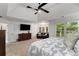 Large main bedroom featuring sitting area, tray ceilings, and large windows with plantation shutters at 820 Chelsea Park Ne Dr, Marietta, GA 30068