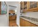 Butlers pantry with granite countertops, glass front cabinets, and direct access to the kitchen at 820 Chelsea Park Ne Dr, Marietta, GA 30068