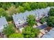 An aerial of townhomes with grey roofs, tree coverage, and decks off the back at 11352 Musette Cir, Alpharetta, GA 30009