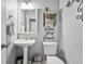 Charming powder room with pedestal sink, decorative shelving, and stylish accents, adding a touch of elegance to the home at 11352 Musette Cir, Alpharetta, GA 30009