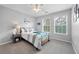 Bright bedroom with plush carpet, neutral walls, a ceiling fan, and a comfortable full-sized bed at 11352 Musette Cir, Alpharetta, GA 30009
