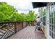 Wide-angle view of the wooden deck area featuring outdoor seating and decorative railings at 11352 Musette Cir, Alpharetta, GA 30009