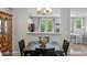 Elegant dining area adjacent to the kitchen, showcasing natural light and a seamless flow for entertaining guests at 11352 Musette Cir, Alpharetta, GA 30009