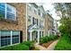 Beautiful townhome with brick and siding exterior, black shutters, and well-manicured landscaping at 11352 Musette Cir, Alpharetta, GA 30009