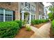 View of townhome exterior with beautiful landscaping and walkway at 11352 Musette Cir, Alpharetta, GA 30009