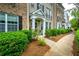 Beautiful townhome with brick and siding exterior, black shutters, and well-manicured landscaping at 11352 Musette Cir, Alpharetta, GA 30009