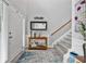 Bright foyer with hardwood floors, staircase, and access to the rest of the home at 11352 Musette Cir, Alpharetta, GA 30009