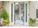 Inviting front entrance with a view of the staircase, accented by flowers and natural light at 11352 Musette Cir, Alpharetta, GA 30009