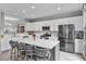 Bright kitchen with white cabinets, stainless steel appliances, and a large center island with seating at 11352 Musette Cir, Alpharetta, GA 30009