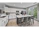 Modern kitchen features white cabinets, stainless steel appliances, and a large island with bar seating at 11352 Musette Cir, Alpharetta, GA 30009