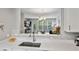 Bright open concept with view from the kitchen to the living room and dining room at 11352 Musette Cir, Alpharetta, GA 30009