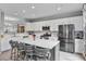 Bright kitchen with a large island, stainless steel appliances, and white cabinetry offers modern convenience at 11352 Musette Cir, Alpharetta, GA 30009