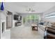 Comfortable living room with a fireplace, a large window, and neutral decor at 11352 Musette Cir, Alpharetta, GA 30009