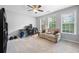 Inviting living room with large windows, flooding the space with natural light and a ceiling fan at 11352 Musette Cir, Alpharetta, GA 30009