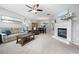 Open living area with a fireplace and neutral tones, creating a warm and inviting space for relaxation and entertaining at 11352 Musette Cir, Alpharetta, GA 30009