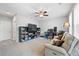 Bright living room with neutral tones, plush carpeting, and a ceiling fan for added comfort at 11352 Musette Cir, Alpharetta, GA 30009