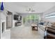 Comfortable living room with a fireplace, large windows, and a cozy seating arrangement at 11352 Musette Cir, Alpharetta, GA 30009