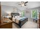 Comfortable main bedroom with a large bed, dresser, bedside tables, and natural light at 11352 Musette Cir, Alpharetta, GA 30009