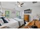 Spacious main bedroom featuring a ceiling fan, TV, dresser, and windows at 11352 Musette Cir, Alpharetta, GA 30009
