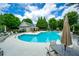 Community pool surrounded by lounge chairs offers a relaxing outdoor amenity for residents at 11352 Musette Cir, Alpharetta, GA 30009