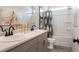 Double sink bathroom vanity with gray cabinets, contemporary faucets, a large mirror, and a shower at 146 Silver Leaf Trce, Douglasville, GA 30134