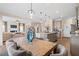 Open concept with large wooden table and dining room looking into kitchen and living room at 146 Silver Leaf Trce, Douglasville, GA 30134