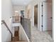 Upstairs hallway featuring wood and metal railings and views to various rooms at 146 Silver Leaf Trce, Douglasville, GA 30134