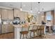 Open kitchen boasts granite counters, stainless appliances, a breakfast bar, and an adjacent dining area at 146 Silver Leaf Trce, Douglasville, GA 30134