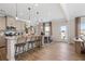 Bright eat-in kitchen featuring an island with bar stools, modern cabinets, and an adjacent dining table at 146 Silver Leaf Trce, Douglasville, GA 30134