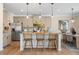 Modern kitchen features stainless steel appliances, an island with barstool seating, and pendant lighting at 146 Silver Leaf Trce, Douglasville, GA 30134
