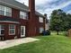 Large brick home with an outdoor patio and well-kept lawn, offering a serene backyard setting at 1498 Park Knoll Trl, Lawrenceville, GA 30043