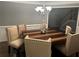 Bright dining room features hardwood table and seating for six at 1498 Park Knoll Trl, Lawrenceville, GA 30043