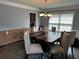 Dining room features hardwood table and chandelier lighting at 1498 Park Knoll Trl, Lawrenceville, GA 30043